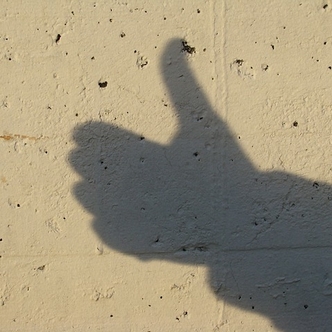 Thumbs up in shadow