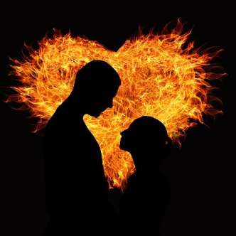 Man and woman in front of fiery heart